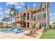Back of home featuring a swimming pool, patio with lounge chairs and manicured green lawn at 5810 Mariner St, Tampa, FL 33609