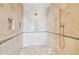 Elegant shower with detailed tile work, bronze fixtures, and built in storage at 5810 Mariner St, Tampa, FL 33609