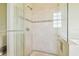 Modern shower features elegant tile detail, glass door, and built-in bench at 5810 Mariner St, Tampa, FL 33609