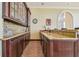 Sophisticated wet bar featuring granite countertops, custom cabinetry, and ample storage at 5810 Mariner St, Tampa, FL 33609