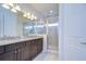 Bathroom boasts a double vanity with granite countertop and glass-enclosed shower at 5933 Caldera Ridge Dr, Lithia, FL 33547