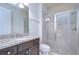 Bathroom boasts a granite countertop vanity and glass-enclosed shower at 5933 Caldera Ridge Dr, Lithia, FL 33547
