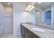 Double vanity bathroom with dual sinks, granite countertops, and well-lit mirrors at 5933 Caldera Ridge Dr, Lithia, FL 33547