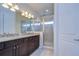 Bathroom boasts a double vanity with granite countertop and glass-enclosed shower at 5933 Caldera Ridge Dr, Lithia, FL 33547