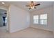 Bedroom has neutral colored carpet, a ceiling fan, and natural light from windows at 5933 Caldera Ridge Dr, Lithia, FL 33547