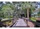 Picturesque wooden boardwalk leads to a community building amidst lush greenery and trees at 5933 Caldera Ridge Dr, Lithia, FL 33547