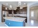 Bright kitchen features a large island, stainless steel appliances, and elegant pendant lighting at 5933 Caldera Ridge Dr, Lithia, FL 33547