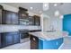 Modern kitchen with dark cabinetry, granite countertops, stainless steel appliances, and stylish lighting at 5933 Caldera Ridge Dr, Lithia, FL 33547