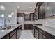 Spacious kitchen with stainless steel appliances, granite counters, and dark cabinets at 5933 Caldera Ridge Dr, Lithia, FL 33547