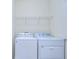 Bright laundry room with white washer and dryer at 5933 Caldera Ridge Dr, Lithia, FL 33547