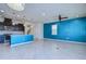 Open-concept living area showcasing tile floors, modern lighting, and a vibrant accent wall at 5933 Caldera Ridge Dr, Lithia, FL 33547