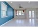 Living room with tile floors, neutral walls, large windows, and a ceiling fan at 5933 Caldera Ridge Dr, Lithia, FL 33547