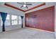 Spacious main bedroom with tray ceiling, ceiling fan and decorative accent wall at 5933 Caldera Ridge Dr, Lithia, FL 33547