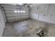 Spacious two-car garage featuring an automatic door and bare walls at 6213 Crickethollow Dr, Riverview, FL 33578