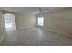 Spacious living room with neutral walls and tile flooring throughout at 6213 Crickethollow Dr, Riverview, FL 33578