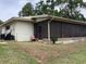 Backyard featuring a screened porch, and tall trees providing ample shade at 6488 Robinswood Ave, Brooksville, FL 34602