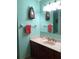 Well-lit bathroom featuring a stylish vanity and a mirrored wall at 6488 Robinswood Ave, Brooksville, FL 34602