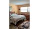 Well-lit bedroom featuring wood floors, windows, and matching bedroom furniture at 6488 Robinswood Ave, Brooksville, FL 34602