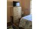 This bedroom has a chest of drawers and a flat screen TV at 6488 Robinswood Ave, Brooksville, FL 34602