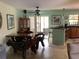 Bright dining area featuring tile flooring, a unique wood table, and easy access to outdoor spaces at 6488 Robinswood Ave, Brooksville, FL 34602