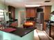 Open kitchen with stainless steel appliances, a breakfast bar, and dark cabinetry at 6488 Robinswood Ave, Brooksville, FL 34602