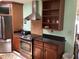 Traditional kitchen with stainless steel appliances, dark countertops, and wood cabinetry at 6488 Robinswood Ave, Brooksville, FL 34602