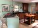 Open-concept kitchen with eat-in counter, a center island, and stainless steel sink at 6488 Robinswood Ave, Brooksville, FL 34602