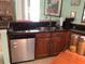 Featuring a dishwasher, sink and wood cabinetry in kitchen at 6488 Robinswood Ave, Brooksville, FL 34602