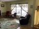 Comfortable chairs in the living room, with a large window providing natural light at 6488 Robinswood Ave, Brooksville, FL 34602