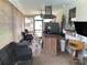 Covered outdoor area featuring an outdoor bar, desk area, and comfortable seating at 6488 Robinswood Ave, Brooksville, FL 34602