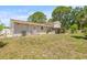 Backyard featuring a covered patio, well-maintained lawn and perimeter fencing at 6607 Larimer Dr, Tampa, FL 33615
