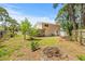 Backyard showcasing the home's exterior and spacious green space at 6607 Larimer Dr, Tampa, FL 33615