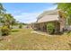 Residential backyard with a screened patio area, lawn and surrounding trees at 6607 Larimer Dr, Tampa, FL 33615