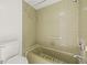 Bathroom with tub shower, toilet and grab bar at 6607 Larimer Dr, Tampa, FL 33615