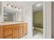 Bathroom features oak vanity and tub with shower at 6607 Larimer Dr, Tampa, FL 33615