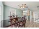 Cozy dining room featuring a ceiling fan, traditional furniture, and a view into the kitchen at 6607 Larimer Dr, Tampa, FL 33615