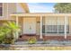 Charming front porch with brick accents, decorative columns, and a well-manicured garden at 6607 Larimer Dr, Tampa, FL 33615