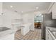 An open kitchen features stainless steel appliances, breakfast bar, and tiled floors at 6607 Larimer Dr, Tampa, FL 33615