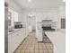 Bright kitchen features white cabinets and stainless steel appliances, offering modern convenience at 6607 Larimer Dr, Tampa, FL 33615