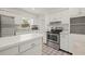 Bright kitchen with white cabinets, stainless appliances, and ample countertop space at 6607 Larimer Dr, Tampa, FL 33615
