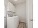 Functional laundry room with washer, dryer, and ample cabinet storage at 6607 Larimer Dr, Tampa, FL 33615