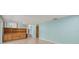 Open living room with laminate floors, built-in shelving, and soft blue walls at 6607 Larimer Dr, Tampa, FL 33615