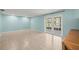 Spacious living room features a sliding glass door and light-colored walls at 6607 Larimer Dr, Tampa, FL 33615