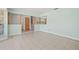 Open living room with tile flooring, natural light, and seamless transitions to other living spaces at 6607 Larimer Dr, Tampa, FL 33615