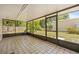 Tiled patio with screens showing views to the backyard; perfect for outdoor enjoyment at 6607 Larimer Dr, Tampa, FL 33615