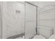 White tiled shower with black decorative floor and glass sliding door; a functional, clean space at 6607 Larimer Dr, Tampa, FL 33615