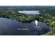 An aerial view showing waterfront access through a canal between Lake Josephine and Rock Lake at 7216 N Mobley Rd, Odessa, FL 33556
