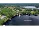 Aerial view showcasing Lake Josephine waterfront properties with mature trees and private docks at 7216 N Mobley Rd, Odessa, FL 33556