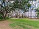 This expansive backyard offers a tranquil escape surrounded by towering trees and vibrant greenery at 7216 N Mobley Rd, Odessa, FL 33556