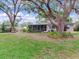 Mature trees offer ample shade for the home's backyard featuring a screened in lanai at 7216 N Mobley Rd, Odessa, FL 33556